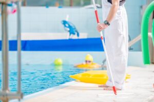 A pool cleaner at the side of a pool