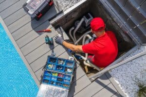 pool technician working on pool heater maintenance