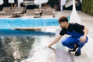 man checking condition of pool heater